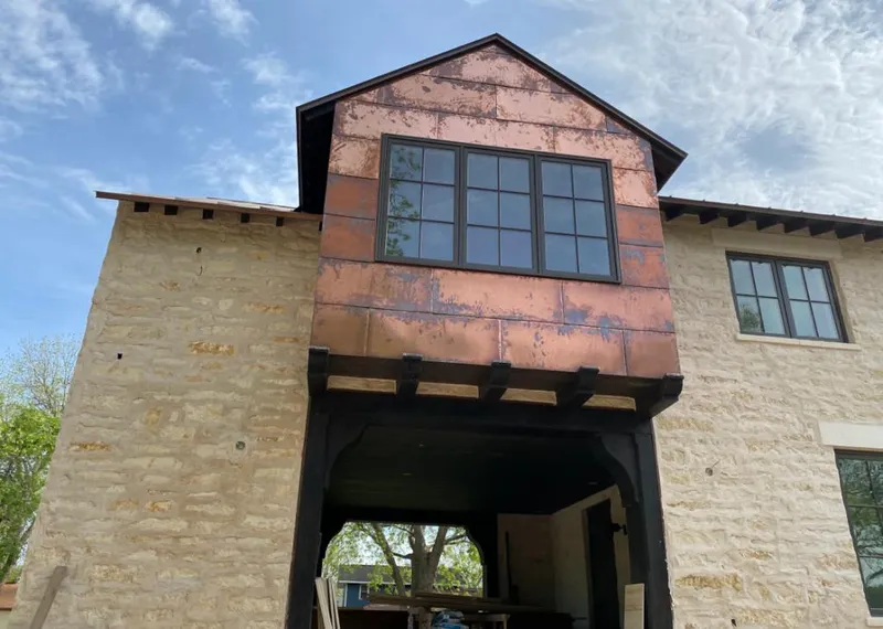 Copper metal panel facade on a stone building for Roof Repair in Turlock