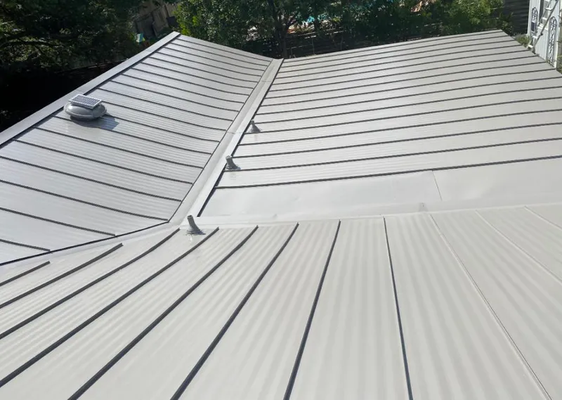 Solar attic fan installed on a metal roof for Roof Ventilation in Turlock